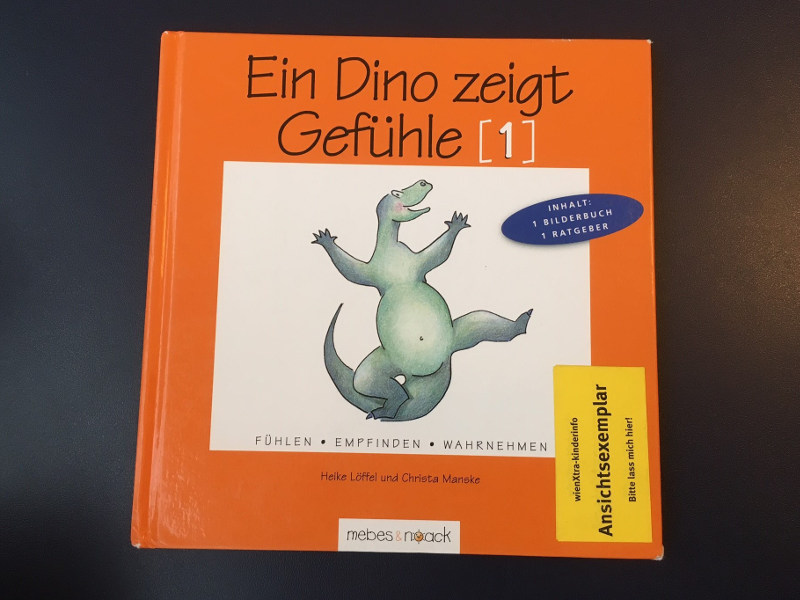 Kinderbuch "Ein Dino zeigt Gefühle" mit einem Ansichtspickerl der WIENXTRA-Kinderinfo