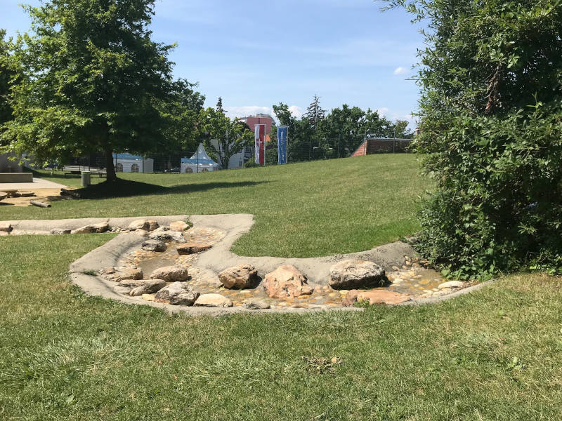 Wiese mit Wasserlauf am Wasserspielplatz Favoriten