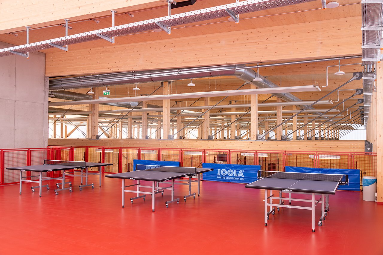 Sicht auf 3 Tischtennis-Tische in einer Halle